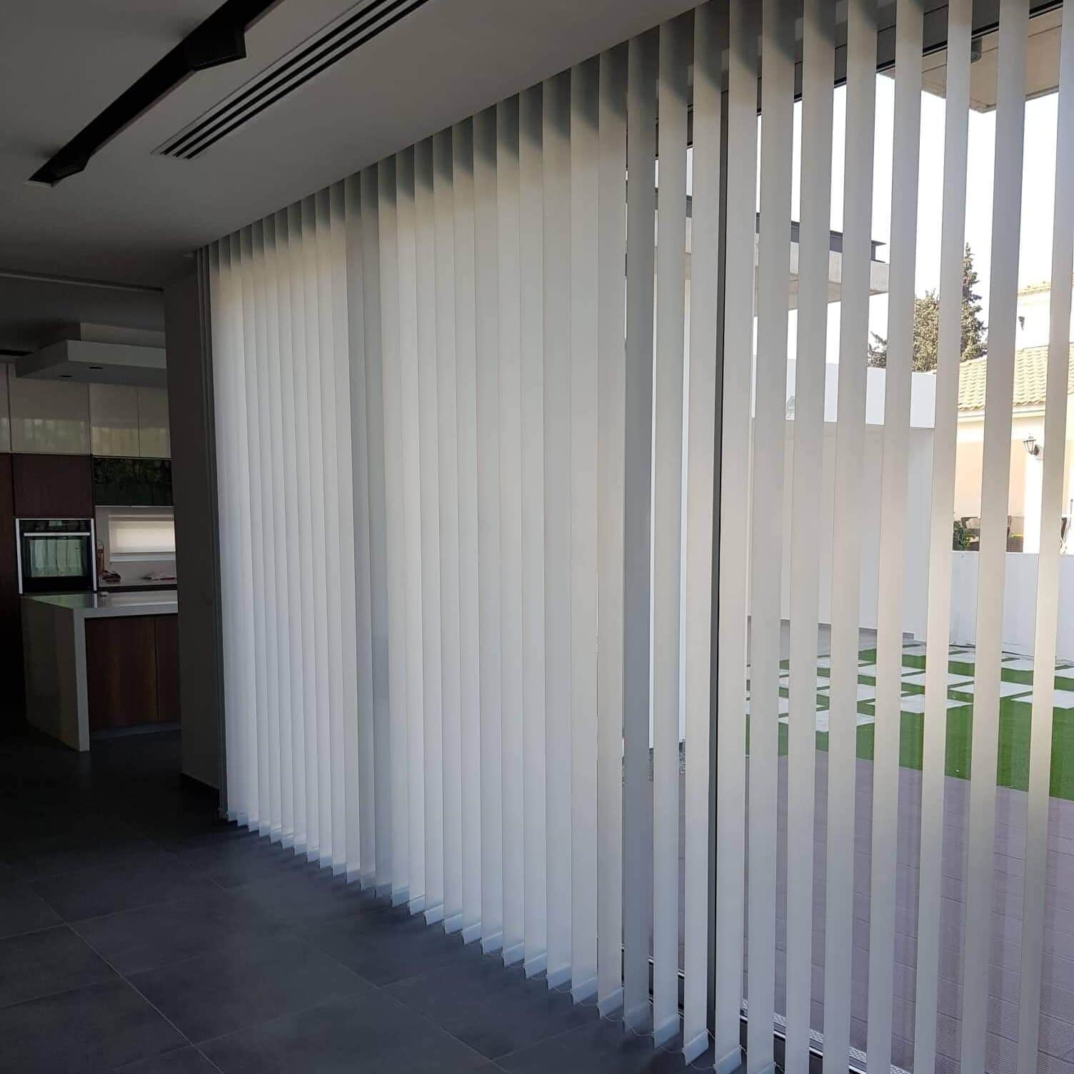 White vertical blackout blinds, practical for these long sliding doors