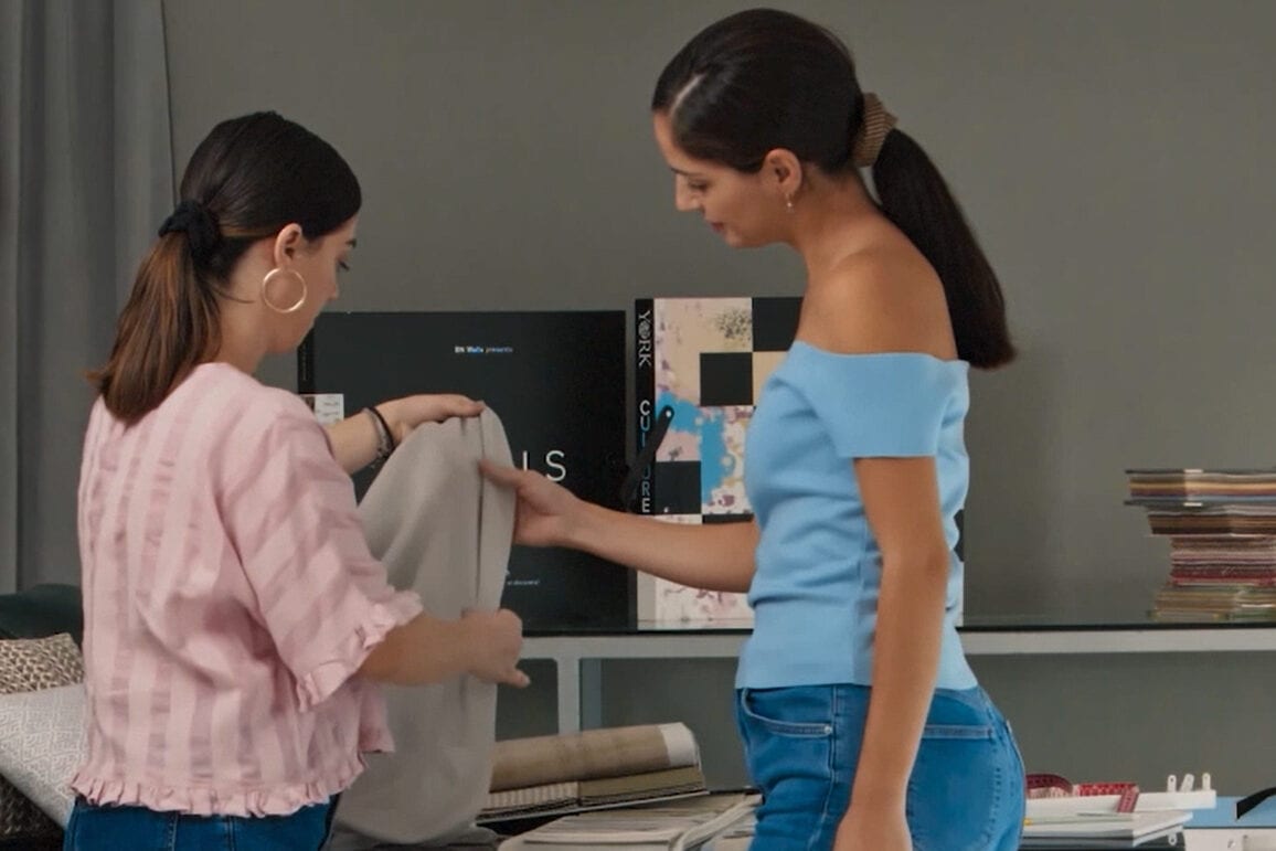 a customer and home collections team looking at fabrics together