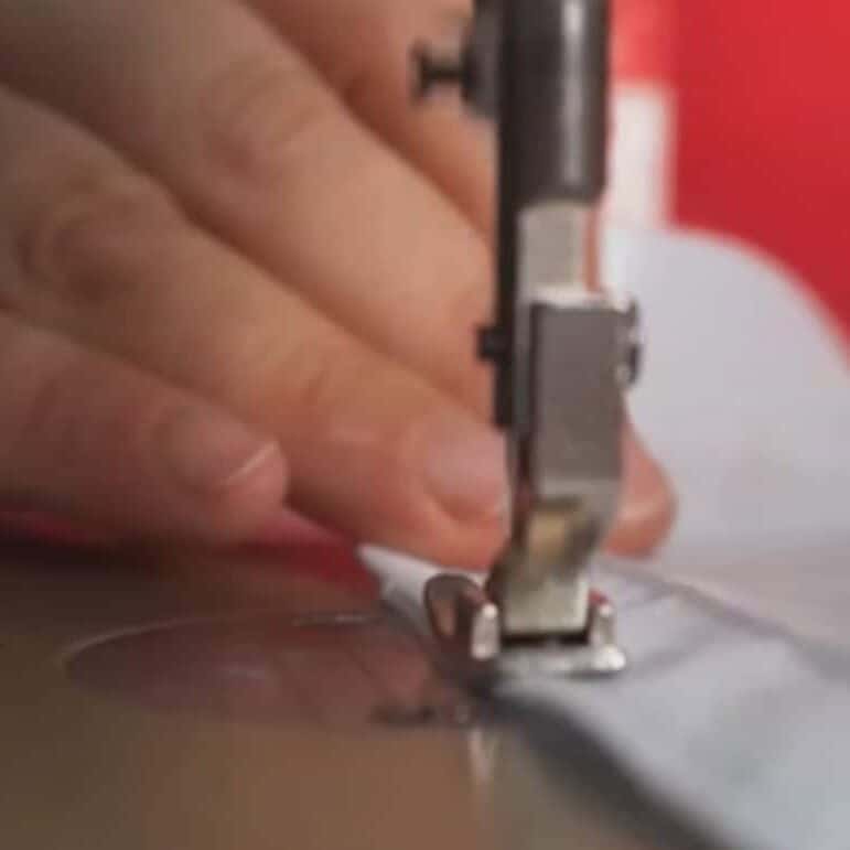 Hand sewing a fabric on a machine