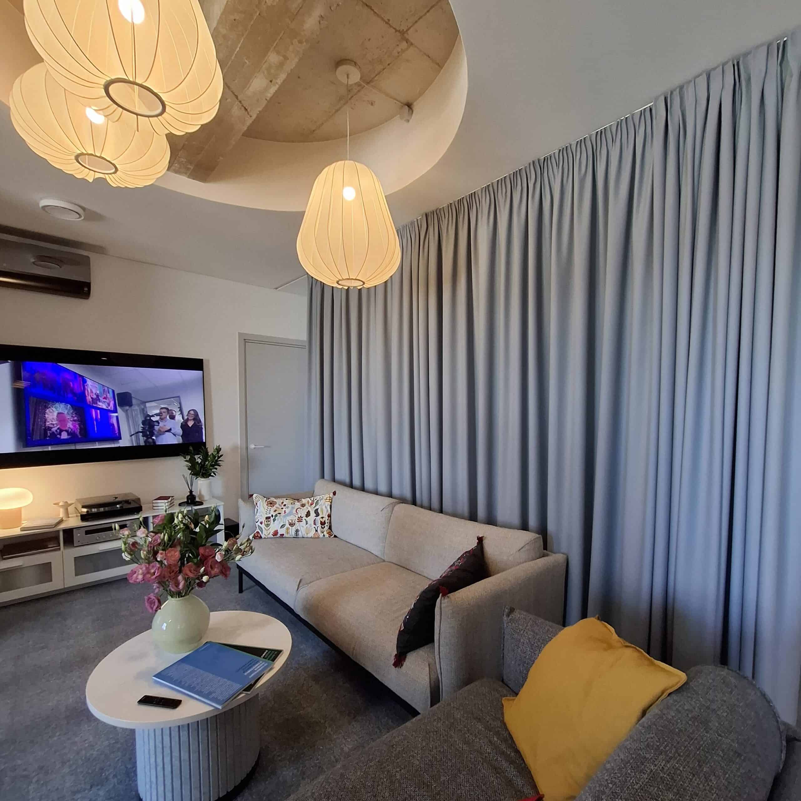 Light grey dimout curtain for an office lounge area