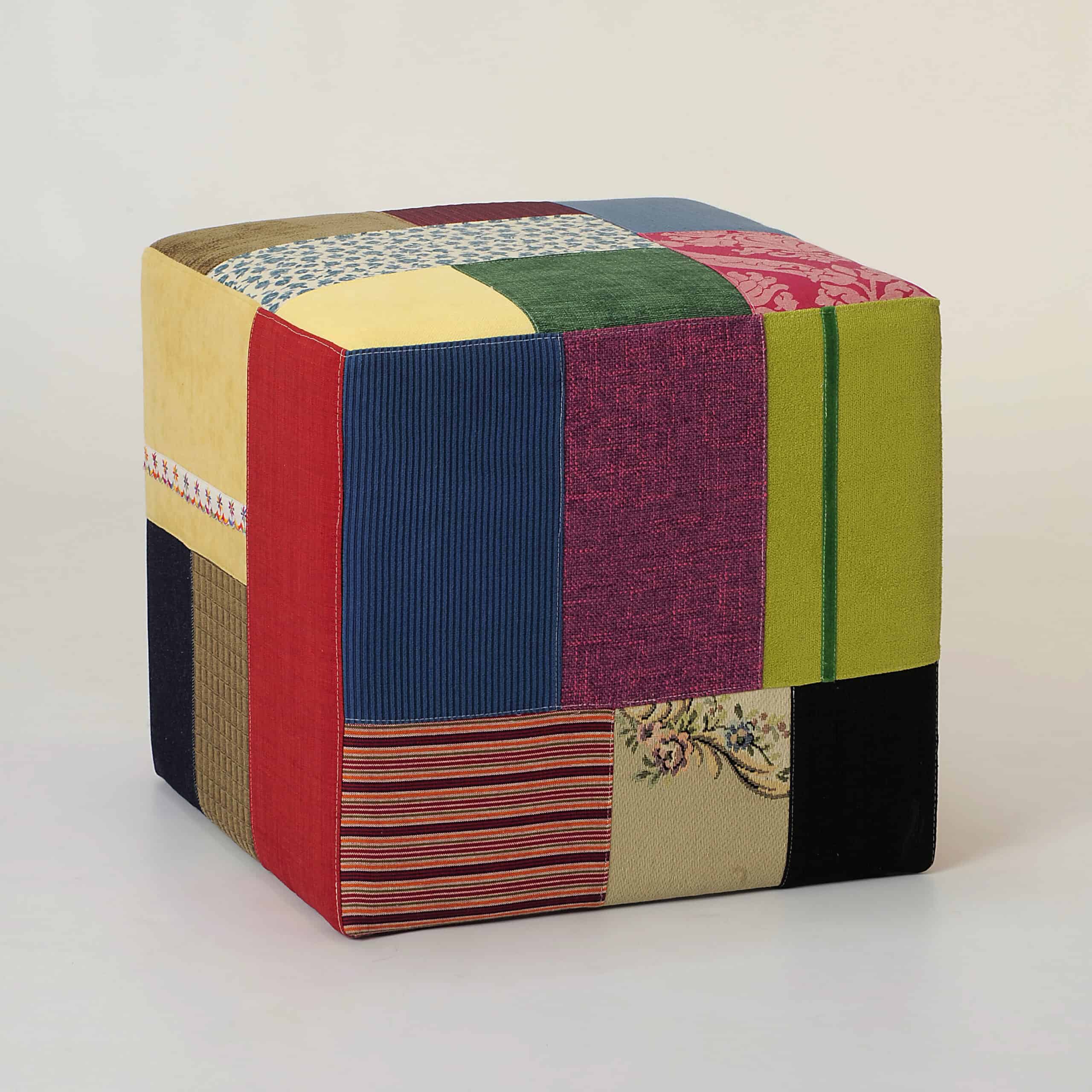Cube pouf with custom patchwork design, blending textures and colours
