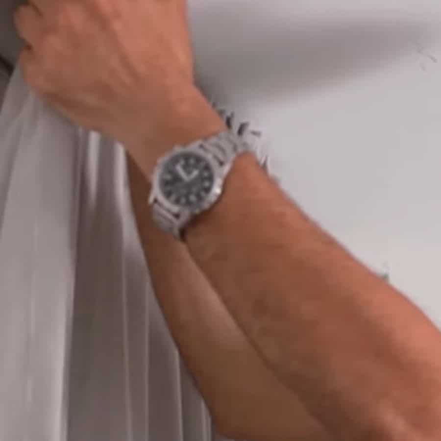 a Home Collection person installing curtains