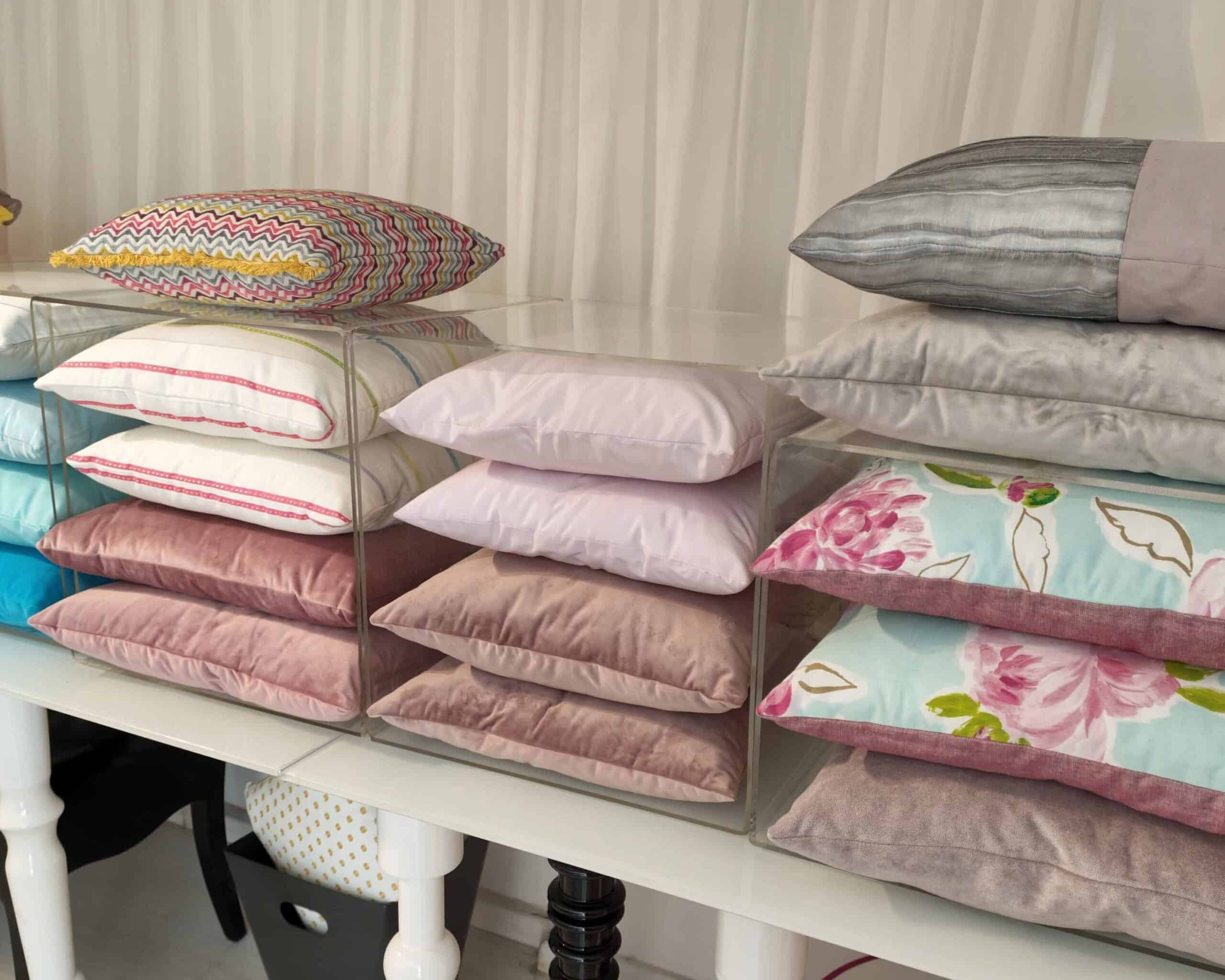 Close up of stacked custom-made cushions of different colours and styles