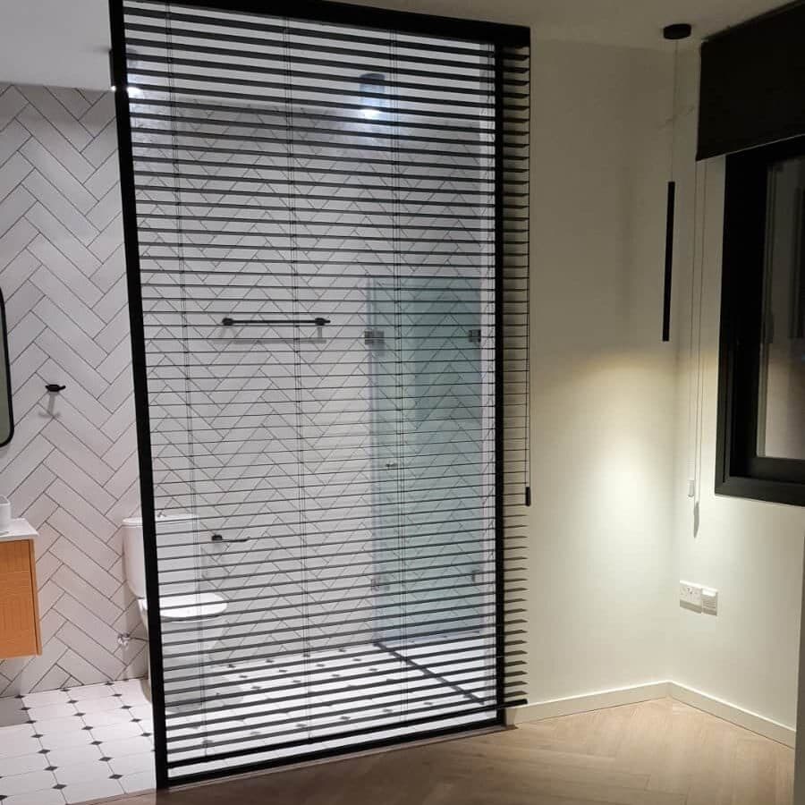 Wooden Venetian 50mm in black, used as a functional privacy divider in a shower