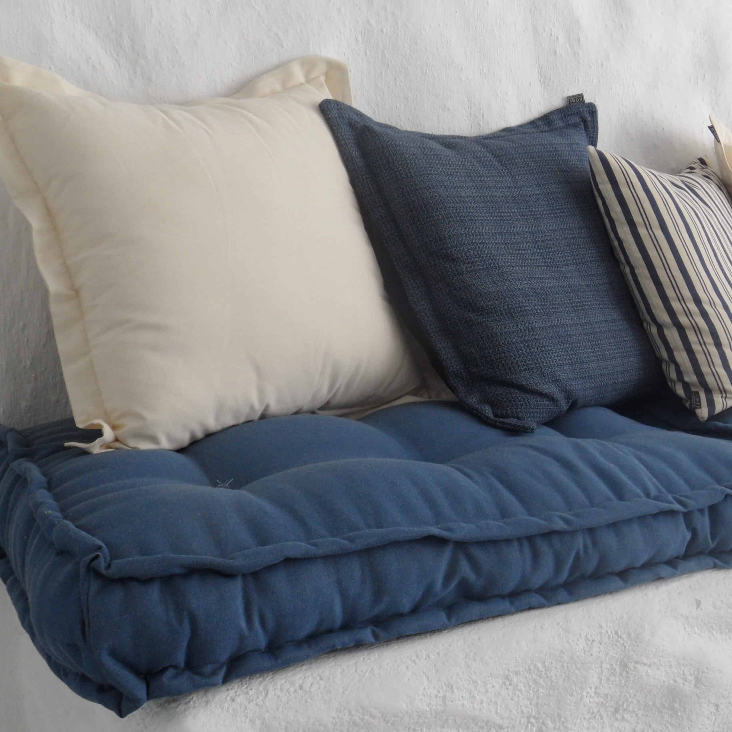 Seat cushion with buttons combined with a selection of back cushions