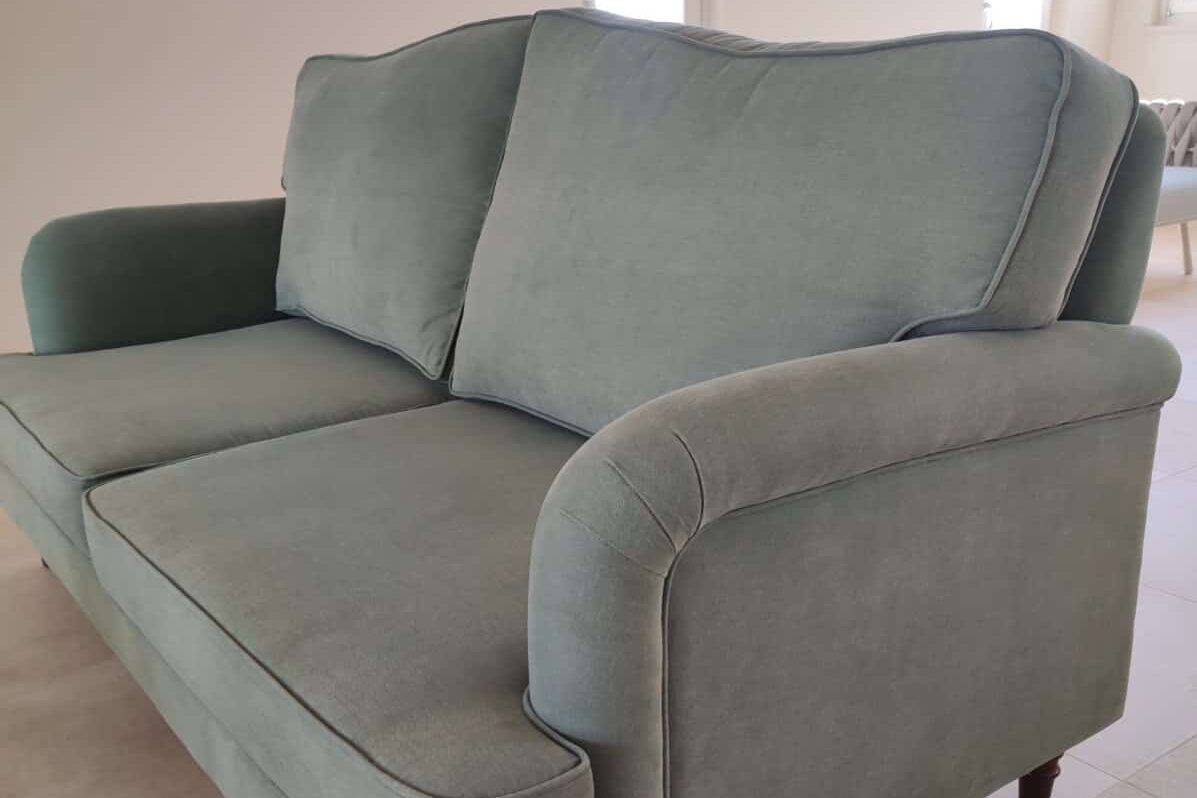 a custom English-style sofa in pine-green upholstery