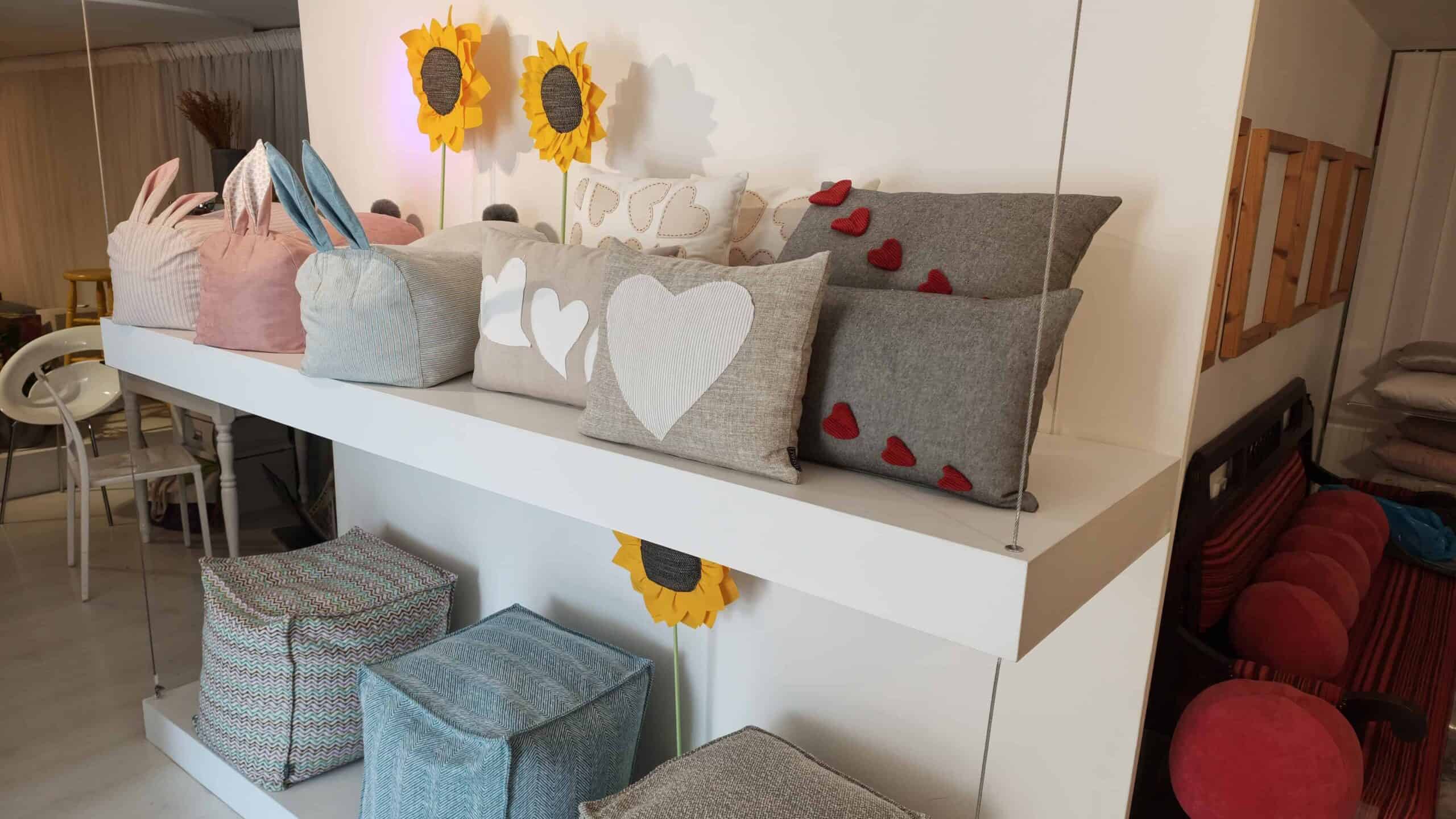 Picture of showroom display with custom-designed poufs and cushions