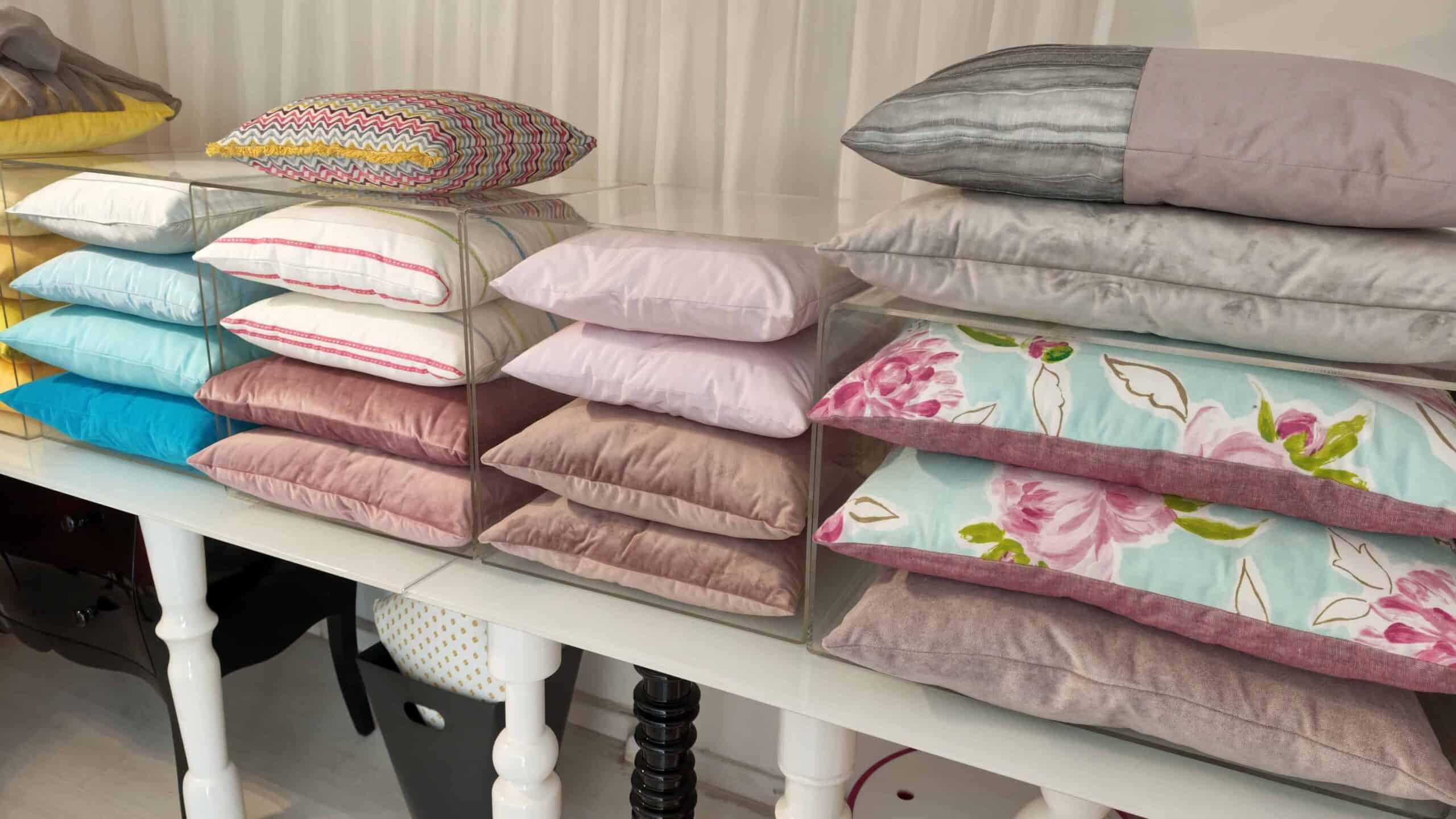Close up of stacked custom-made cushions of different colours and styles