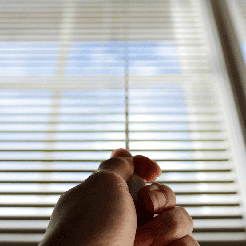 Hand testing the controls of a blind